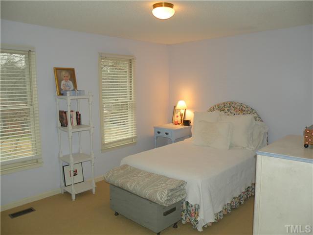 1346 Baez Street Raleigh, NC 27608 - Photo 10 of 12 a bedroom with a bed and a window