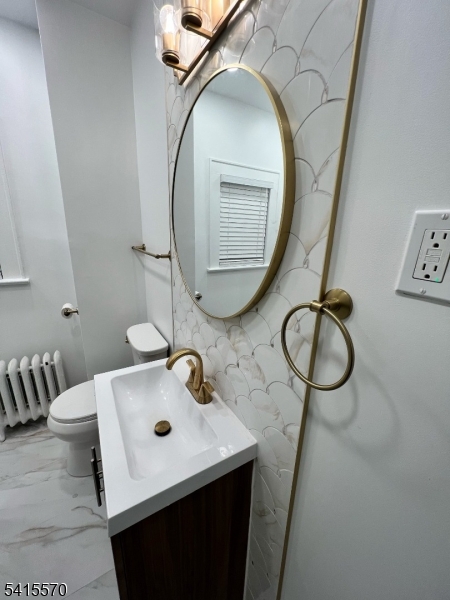 186 Main Avenue Passaic, NJ 07055 - Photo 11 of 13 a bathroom with a sink and a mirror