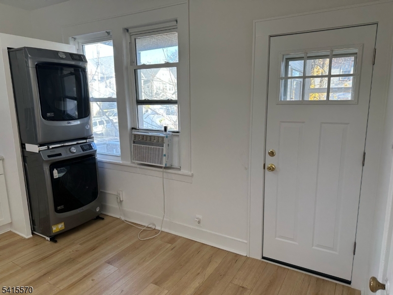 186 Main Avenue Passaic, NJ 07055 - Photo 9 of 13 a living room with a fireplace furniture a flat screen tv and a window