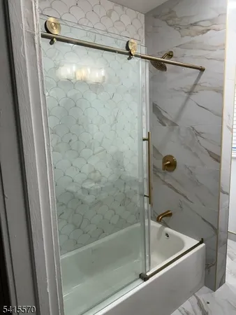 a bathroom with a shower and a bath tub