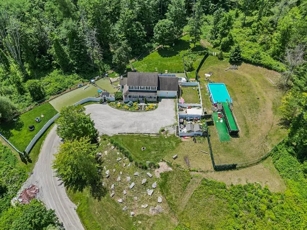 an aerial view of a house with outdoor space