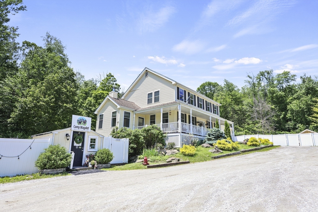 21 East Street Stockbridge, MA 01262 - Photo 5 of 11 a front view of a house with a yard and potted plants