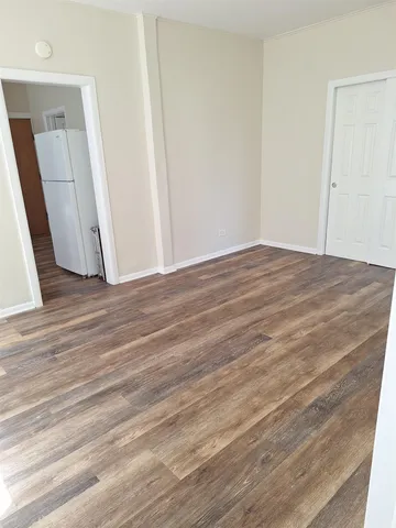 a view of a room with wooden floor and brick wall
