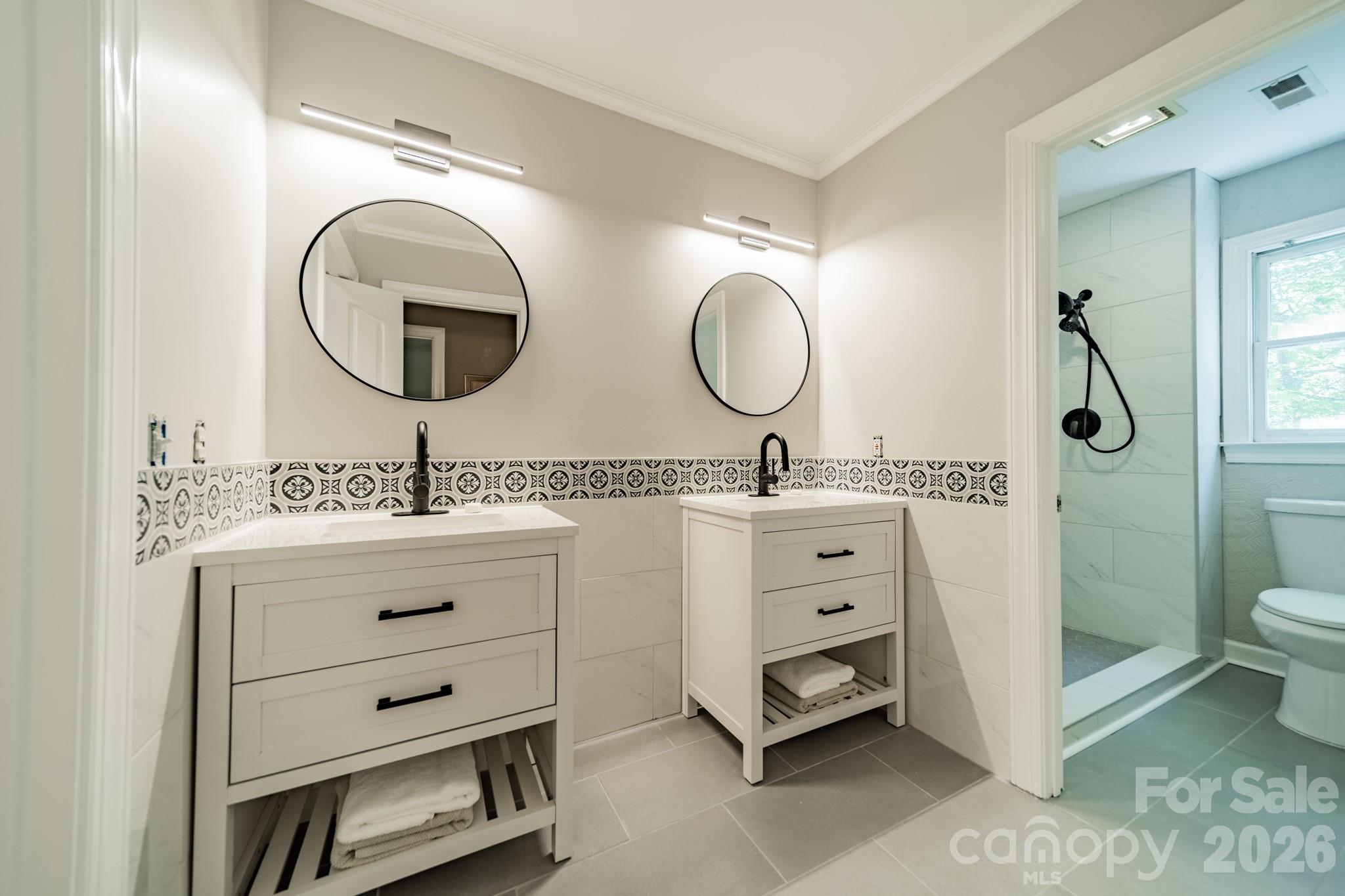 11043 Seven Coves Drive Tega Cay, SC 29708 - Photo 32 of 45 a bathroom with a double vanity sink and a mirror