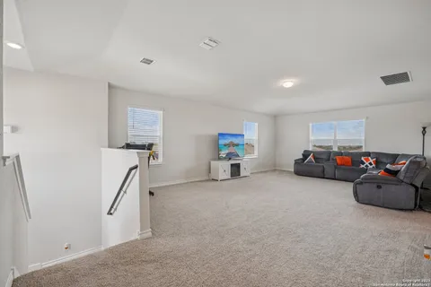 a en suite bathroom with a double vanity sink a mirror and a bathtub