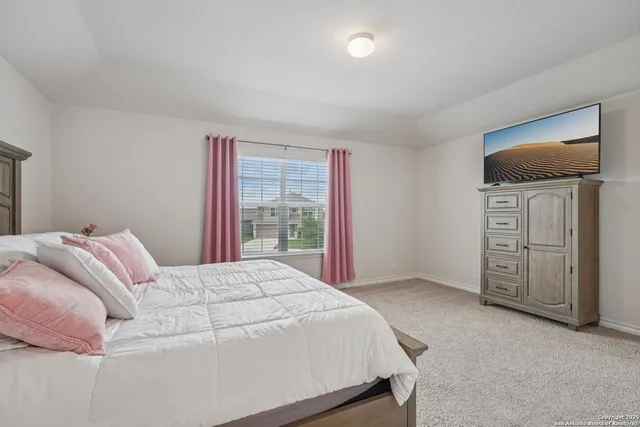 a bedroom with a bed and flat screen tv