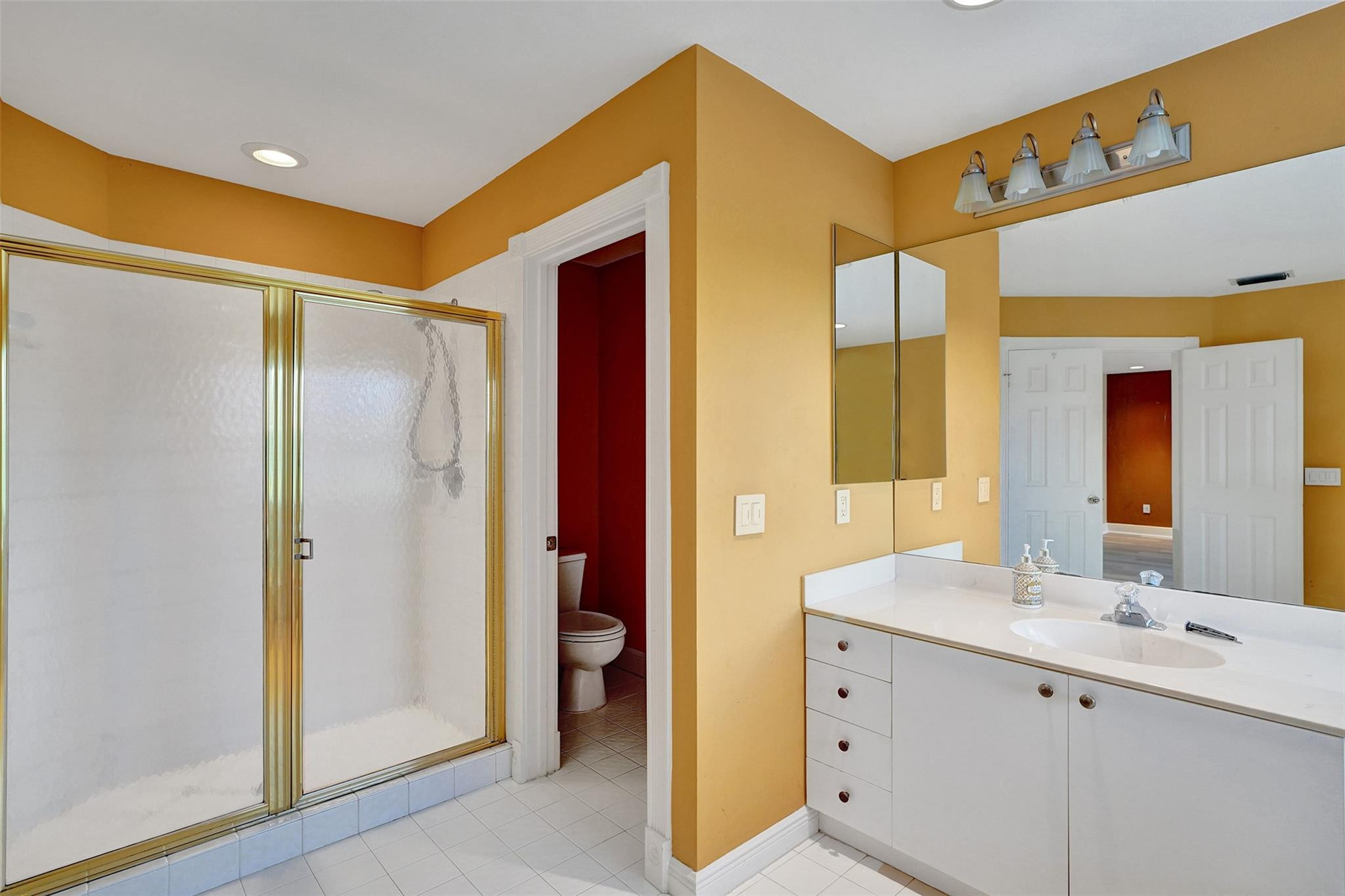 10902 Tamoron Lane Boca Raton, FL 33498 - Photo 37 of 66 a bathroom with a double vanity sink mirror and shower