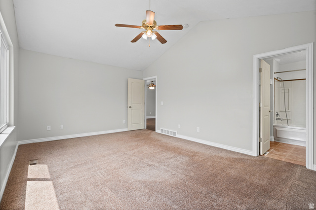 1346 Archmore Drive Springville, UT 84663 - Photo 16 of 32 Spacious room featuring vaulted ceilings, neutral-toned carpeting, and a ceiling fan with light fixture