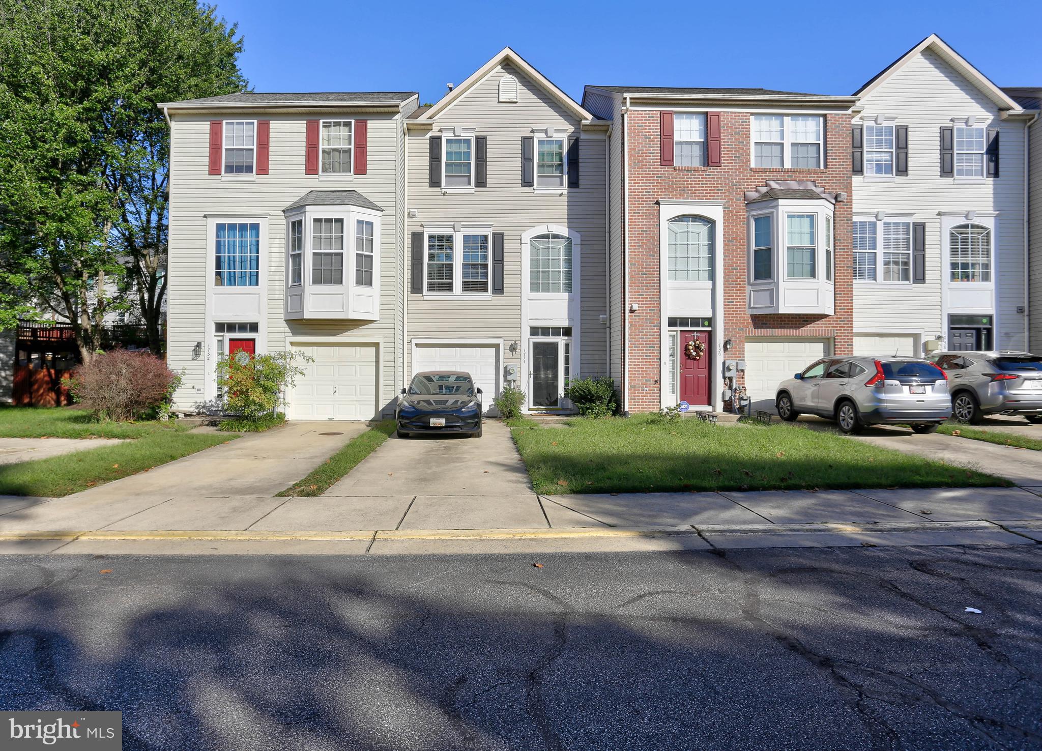 a front view of a residential apartment building with a yard