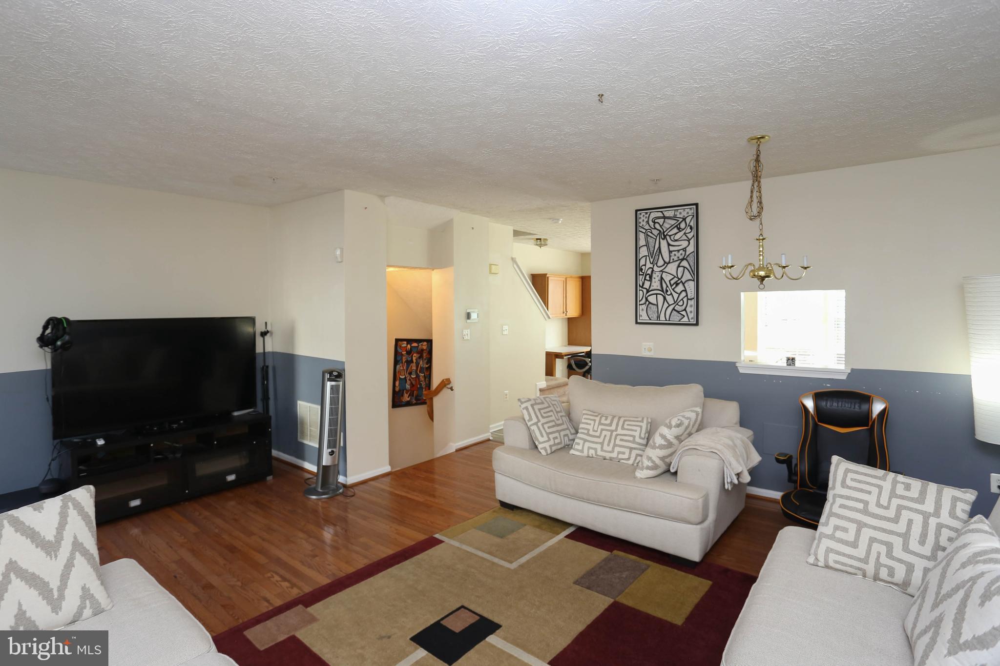 1734 Sea Pine Circle, Unit 136 Severn, MD 21144 - Photo 11 of 32 a living room with furniture and a flat screen tv