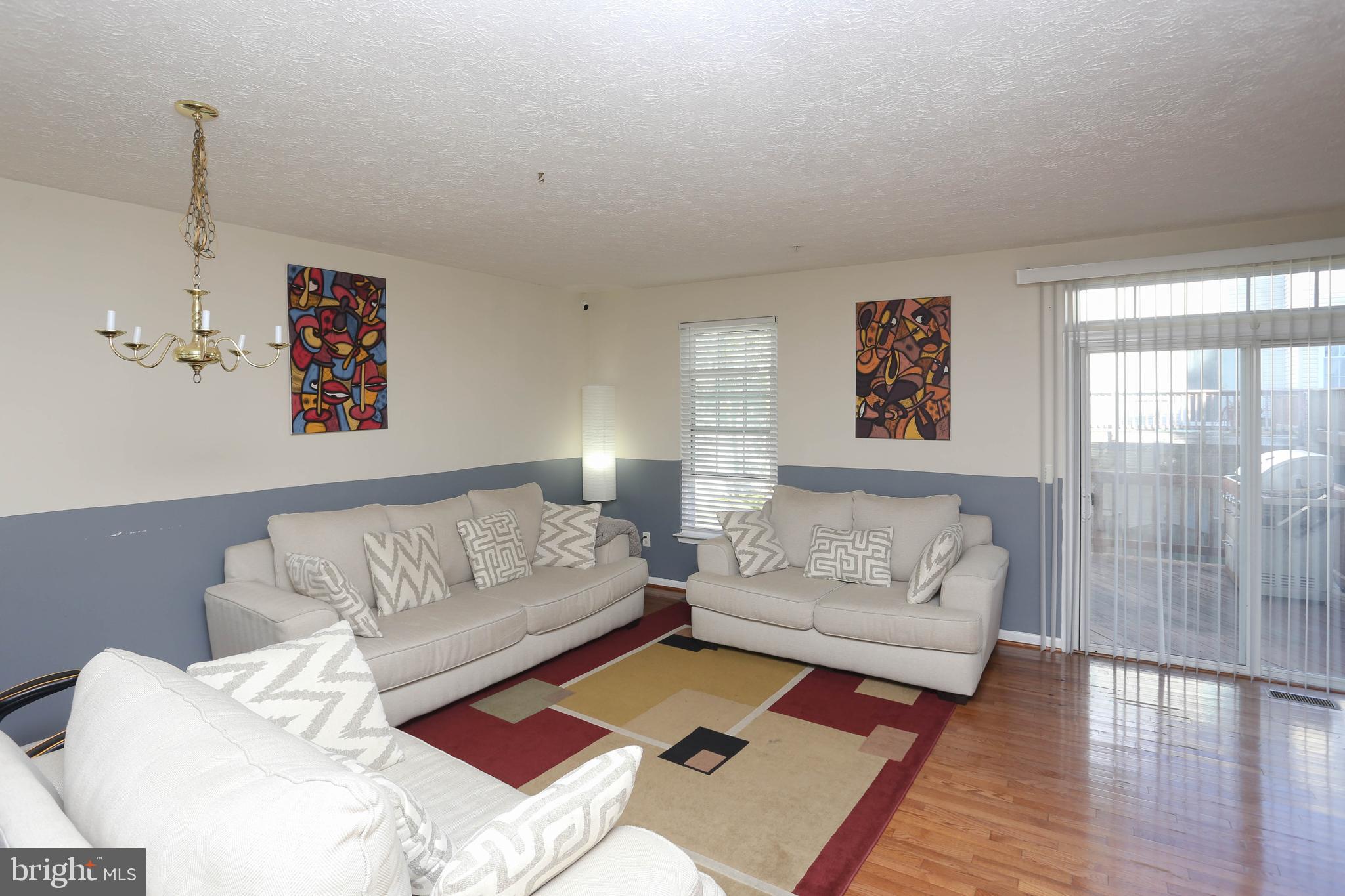 1734 Sea Pine Circle, Unit 136 Severn, MD 21144 - Photo 12 of 32 a living room with furniture and a rug