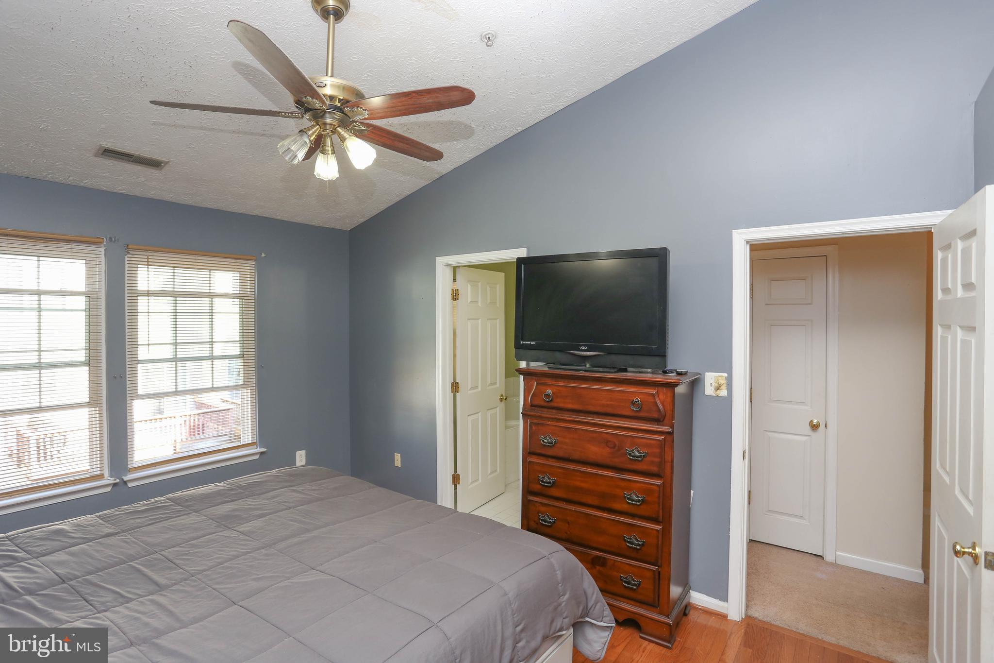1734 Sea Pine Circle, Unit 136 Severn, MD 21144 - Photo 17 of 32 a bedroom with a bed and a flat screen tv