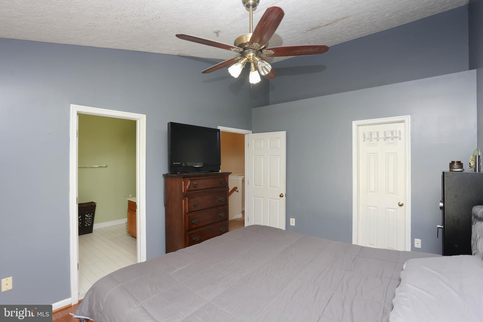 1734 Sea Pine Circle, Unit 136 Severn, MD 21144 - Photo 18 of 32 a bedroom with a bed and a flat screen tv