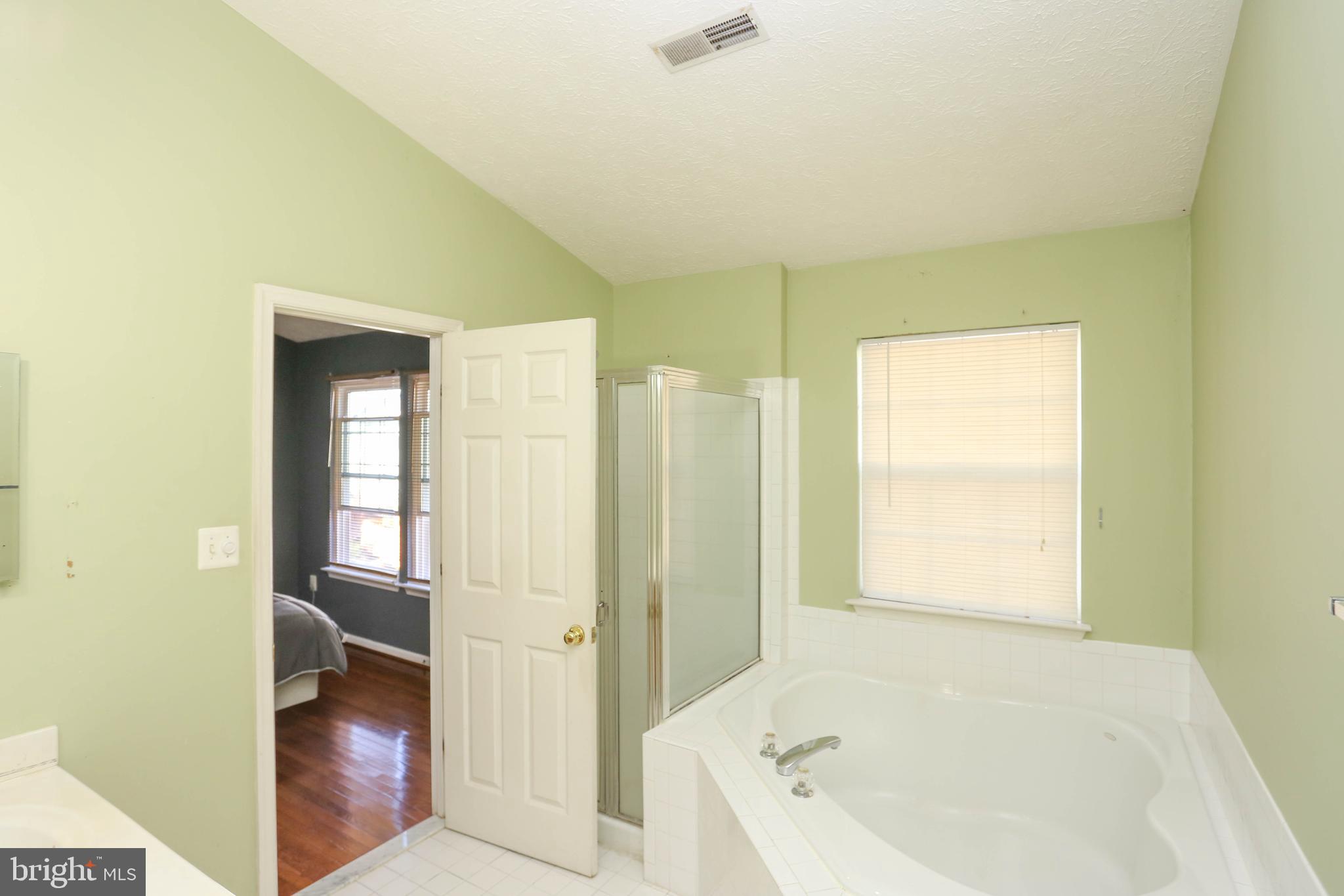 1734 Sea Pine Circle, Unit 136 Severn, MD 21144 - Photo 20 of 32 a bathroom with a bathtub and a sink