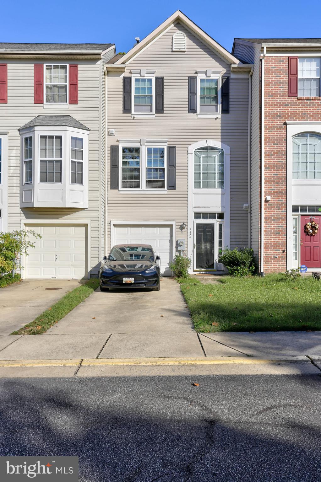 1734 Sea Pine Circle, Unit 136 Severn, MD 21144 - Photo 2 of 32 a front view of a house with a yard