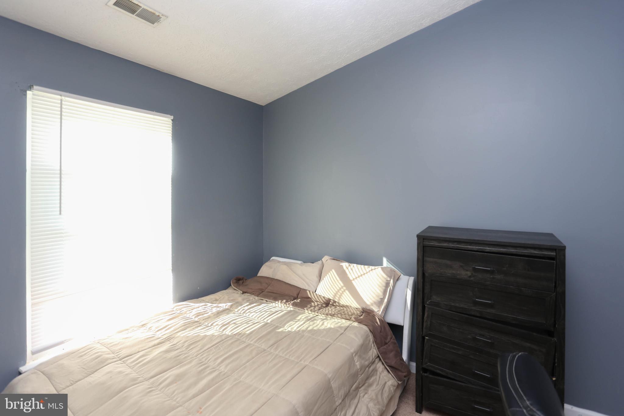 1734 Sea Pine Circle, Unit 136 Severn, MD 21144 - Photo 22 of 32 a bedroom with a bed and a window