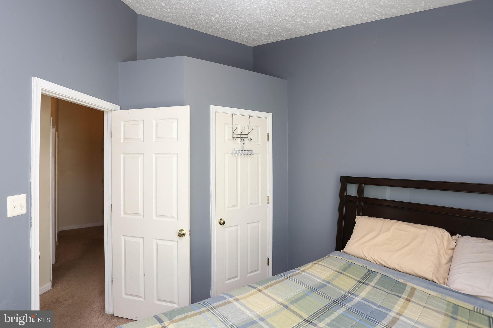 1734 Sea Pine Circle, Unit 136 Severn, MD 21144 - Photo 24 of 32 a bedroom with a bed and a closet