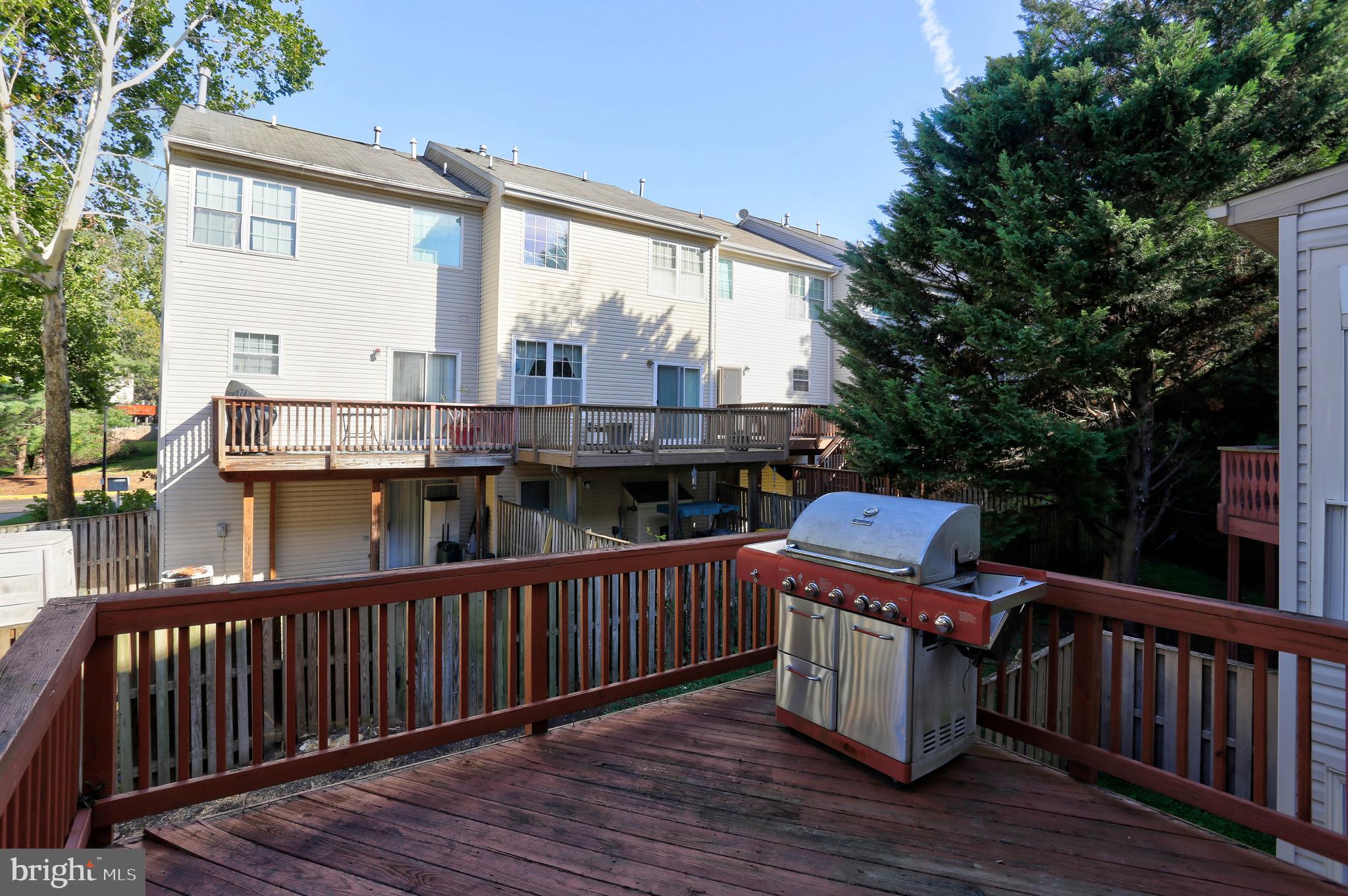 1734 Sea Pine Circle, Unit 136 Severn, MD 21144 - Photo 30 of 32 a view of a deck with wooden floor and fence