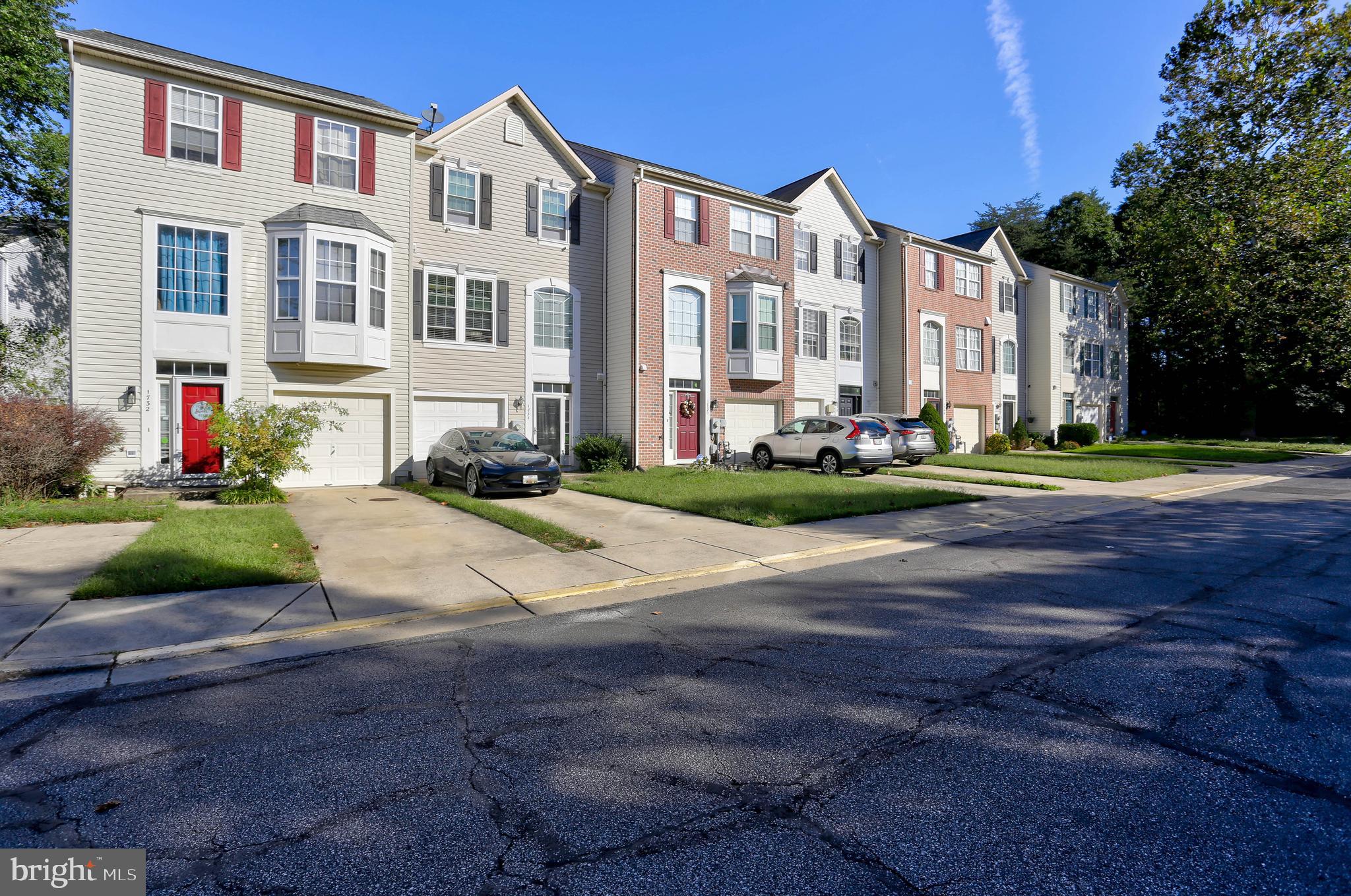 1734 Sea Pine Circle, Unit 136 Severn, MD 21144 - Photo 3 of 32 a front view of a residential apartment building with a yard