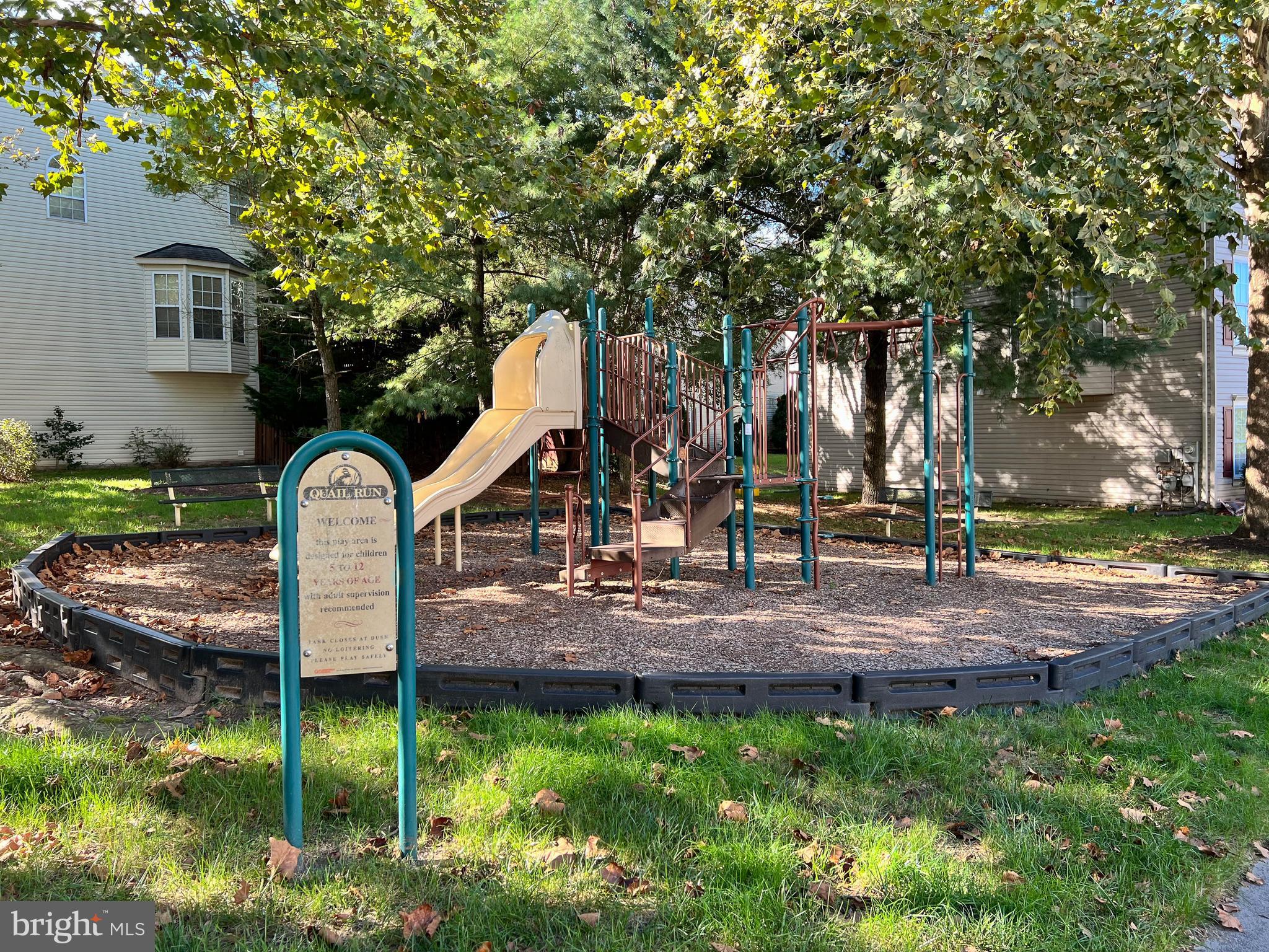 1734 Sea Pine Circle, Unit 136 Severn, MD 21144 - Photo 31 of 32 a front view of a house with garden