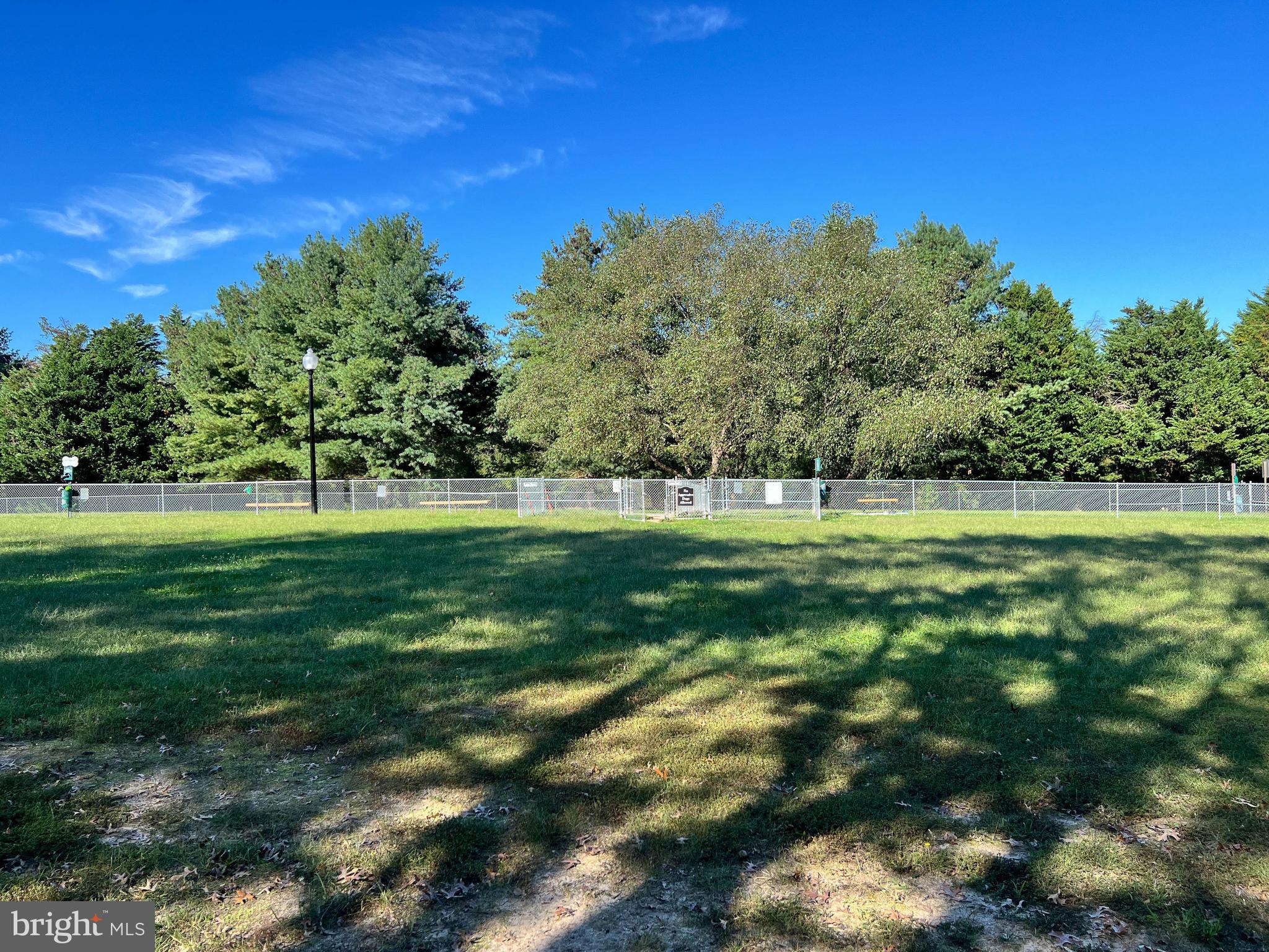 1734 Sea Pine Circle, Unit 136 Severn, MD 21144 - Photo 32 of 32 a view of a green field with trees in the background