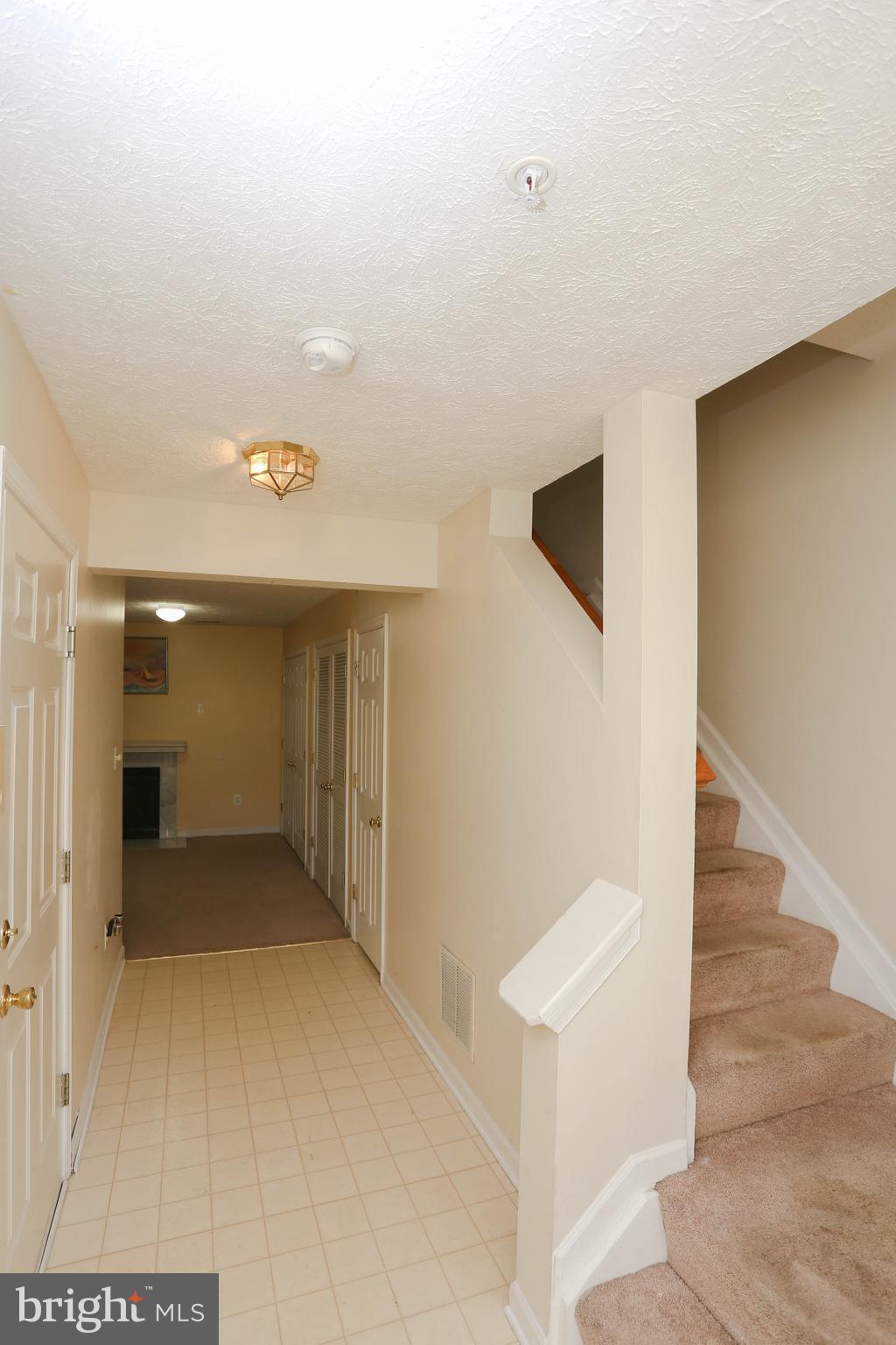 1734 Sea Pine Circle, Unit 136 Severn, MD 21144 - Photo 4 of 32 a view of a hallway with wooden floor and staircase