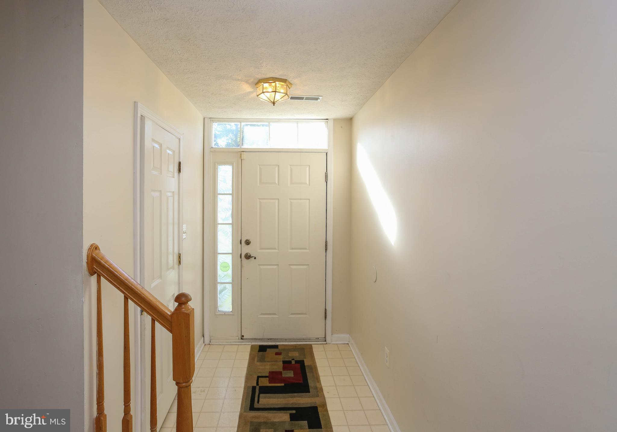 1734 Sea Pine Circle, Unit 136 Severn, MD 21144 - Photo 6 of 32 a view of a hallway with wooden floor and a bathroom