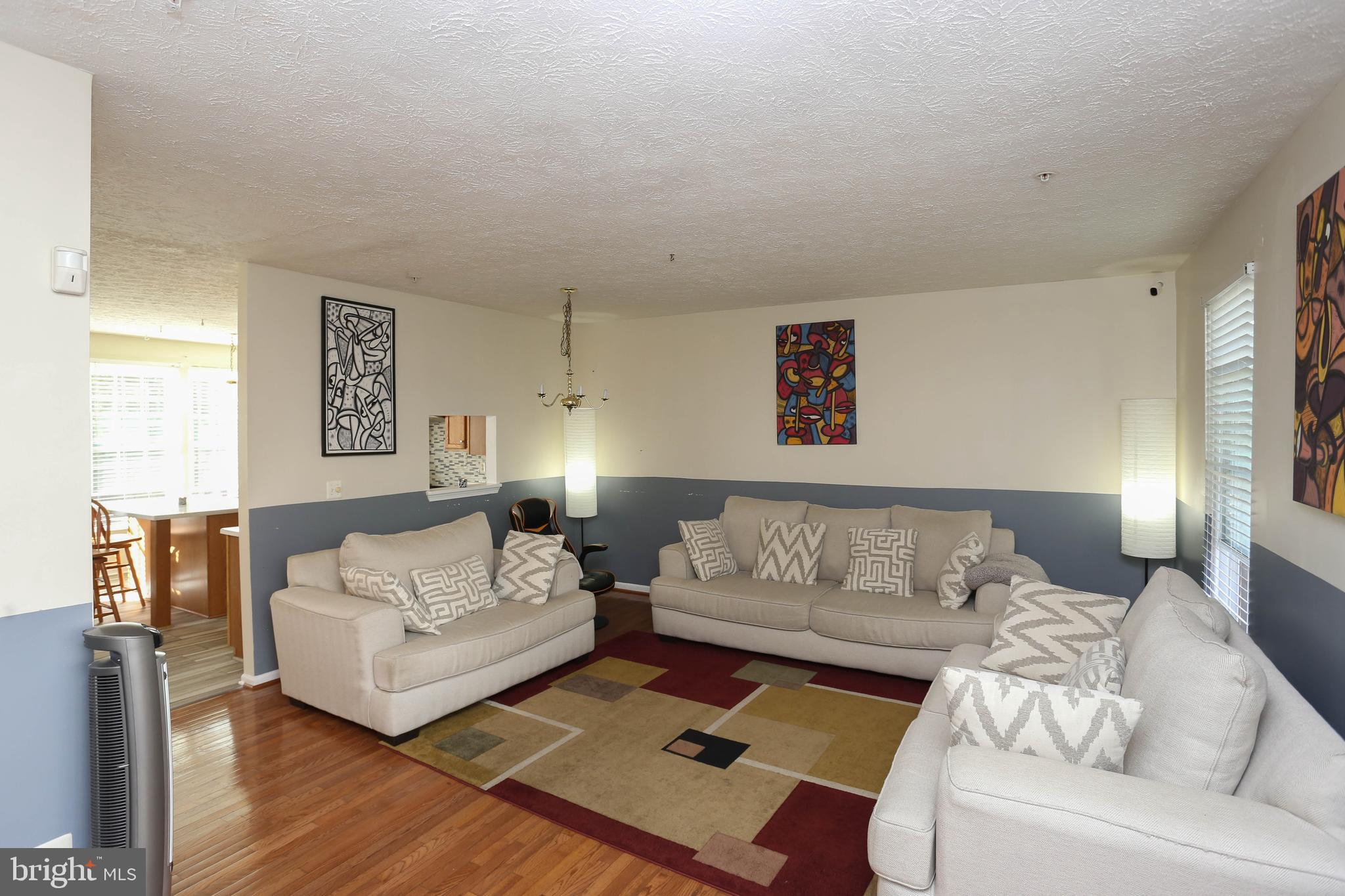 1734 Sea Pine Circle, Unit 136 Severn, MD 21144 - Photo 10 of 32 a living room with furniture and a couch