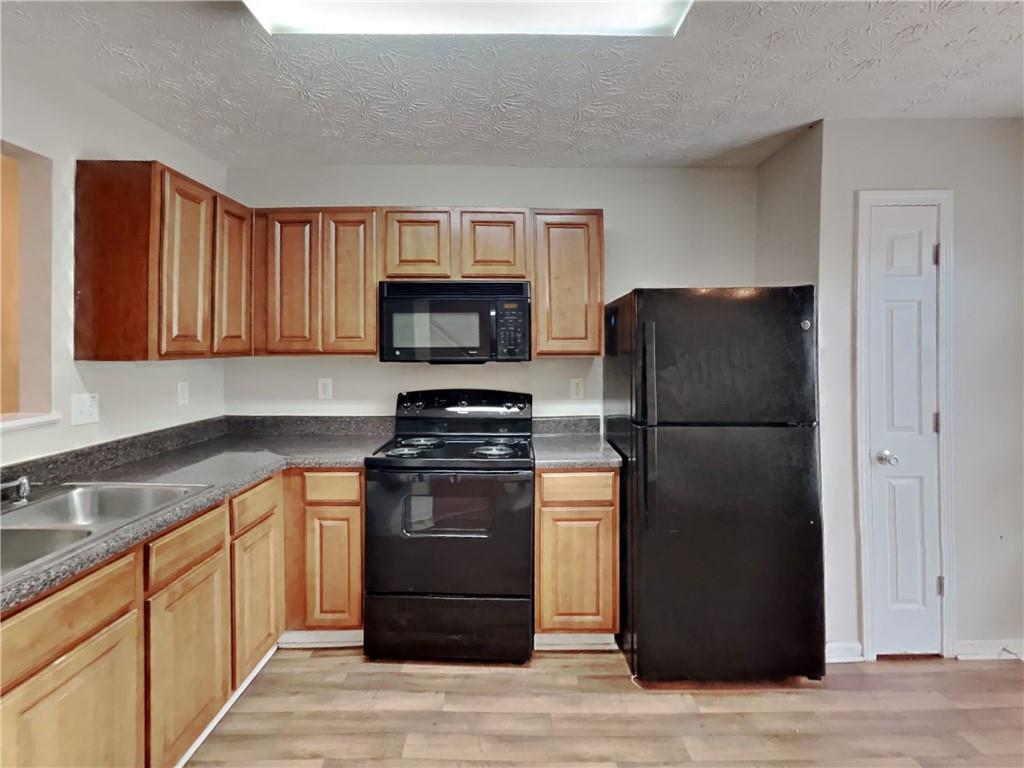 3527 Waldrop Trail Decatur, GA 30034 - Photo 6 of 20 a kitchen with stainless steel appliances granite countertop a refrigerator stove and sink