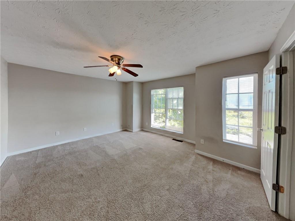 3527 Waldrop Trail Decatur, GA 30034 - Photo 10 of 20 an empty room with windows and ceiling fan view