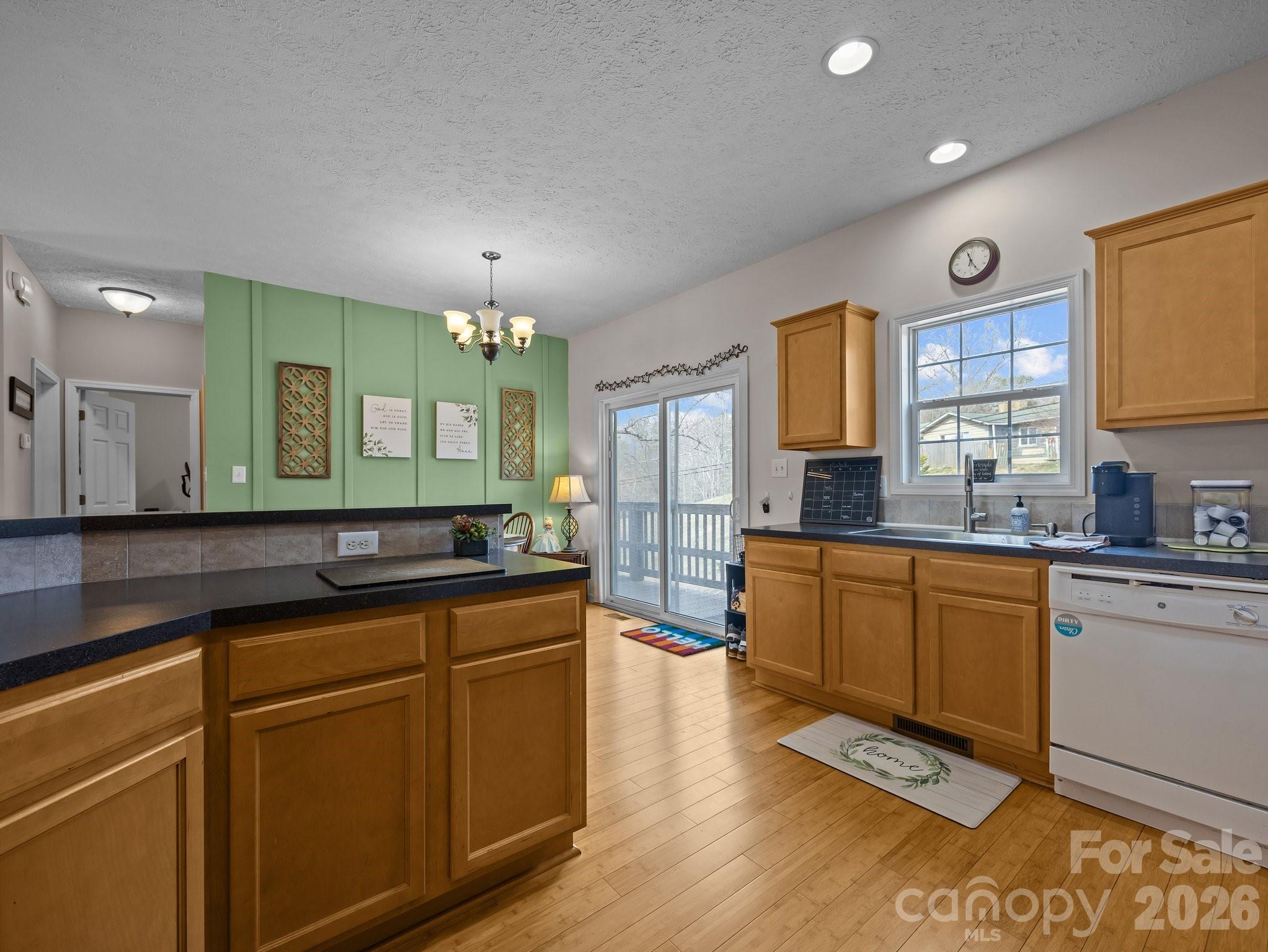 233 Thompson Cv Road Clyde, NC 28721 - Photo 12 of 24 a kitchen with stainless steel appliances granite countertop a sink stove and cabinets