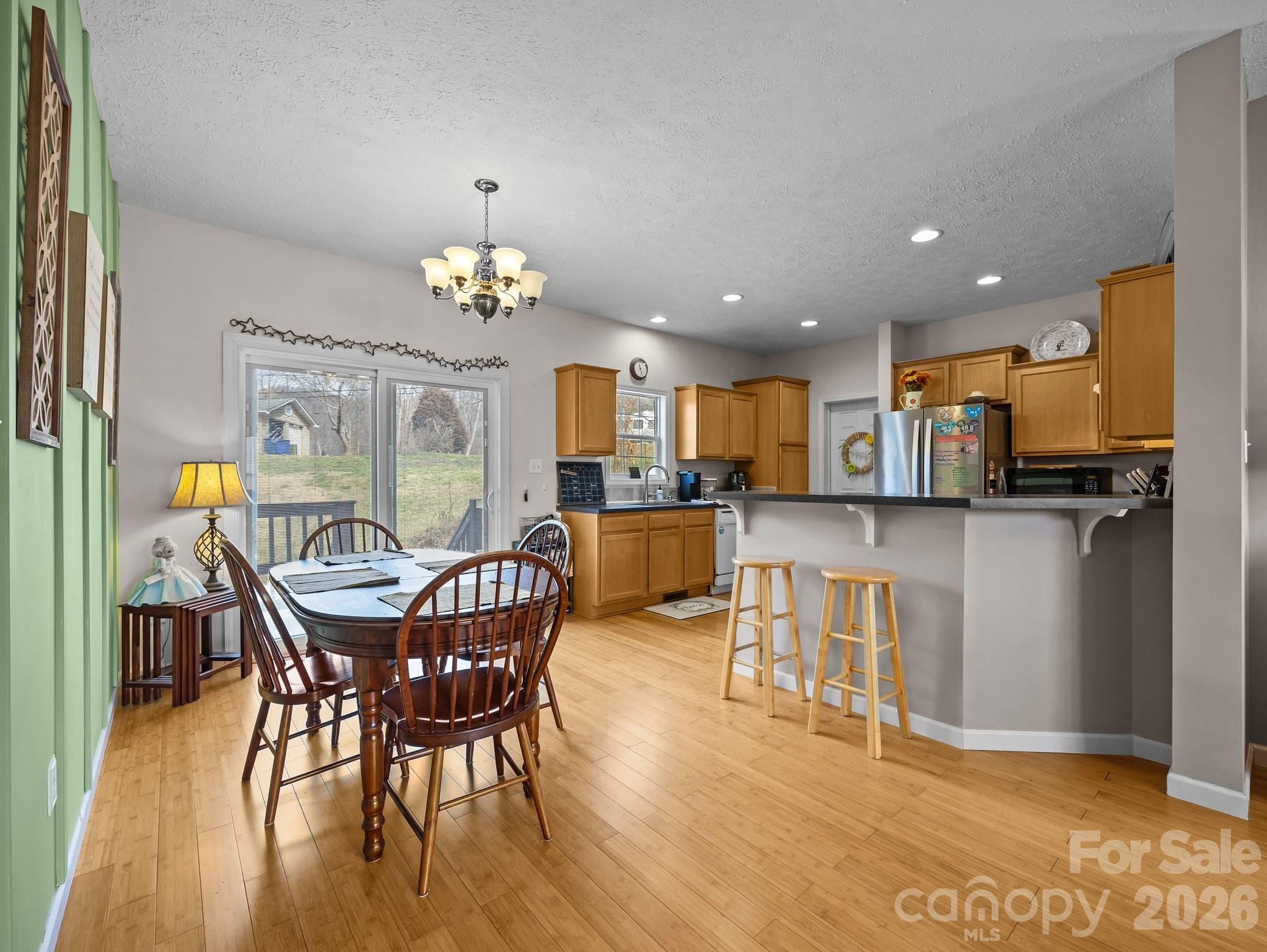 233 Thompson Cv Road Clyde, NC 28721 - Photo 13 of 24 a view of a dining room with furniture and wooden floor
