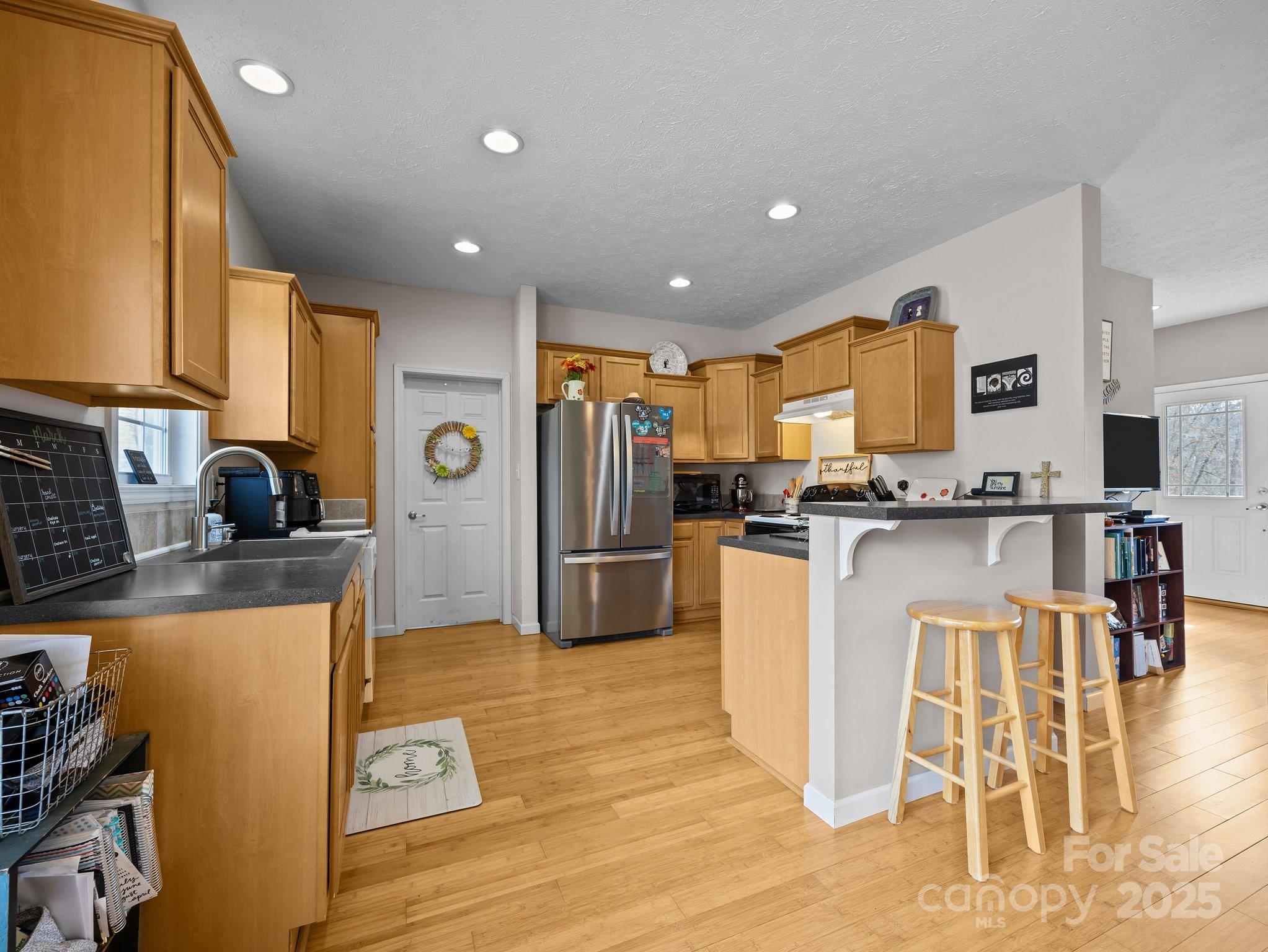 233 Thompson Cv Road Clyde, NC 28721 - Photo 15 of 25 a kitchen with stainless steel appliances granite countertop a refrigerator a stove top oven and a sink