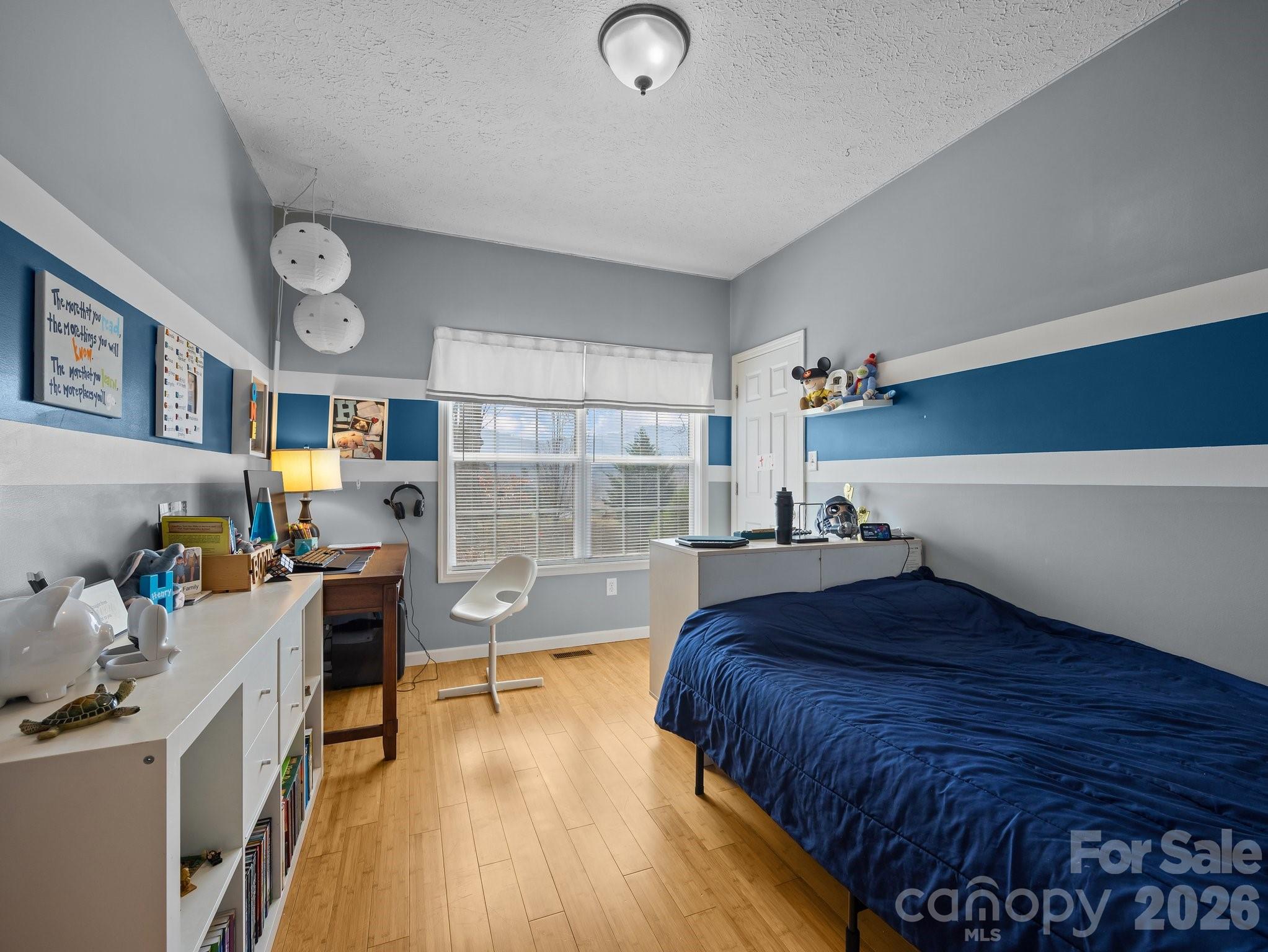 233 Thompson Cv Road Clyde, NC 28721 - Photo 17 of 24 a bedroom with a bed and a wooden floor