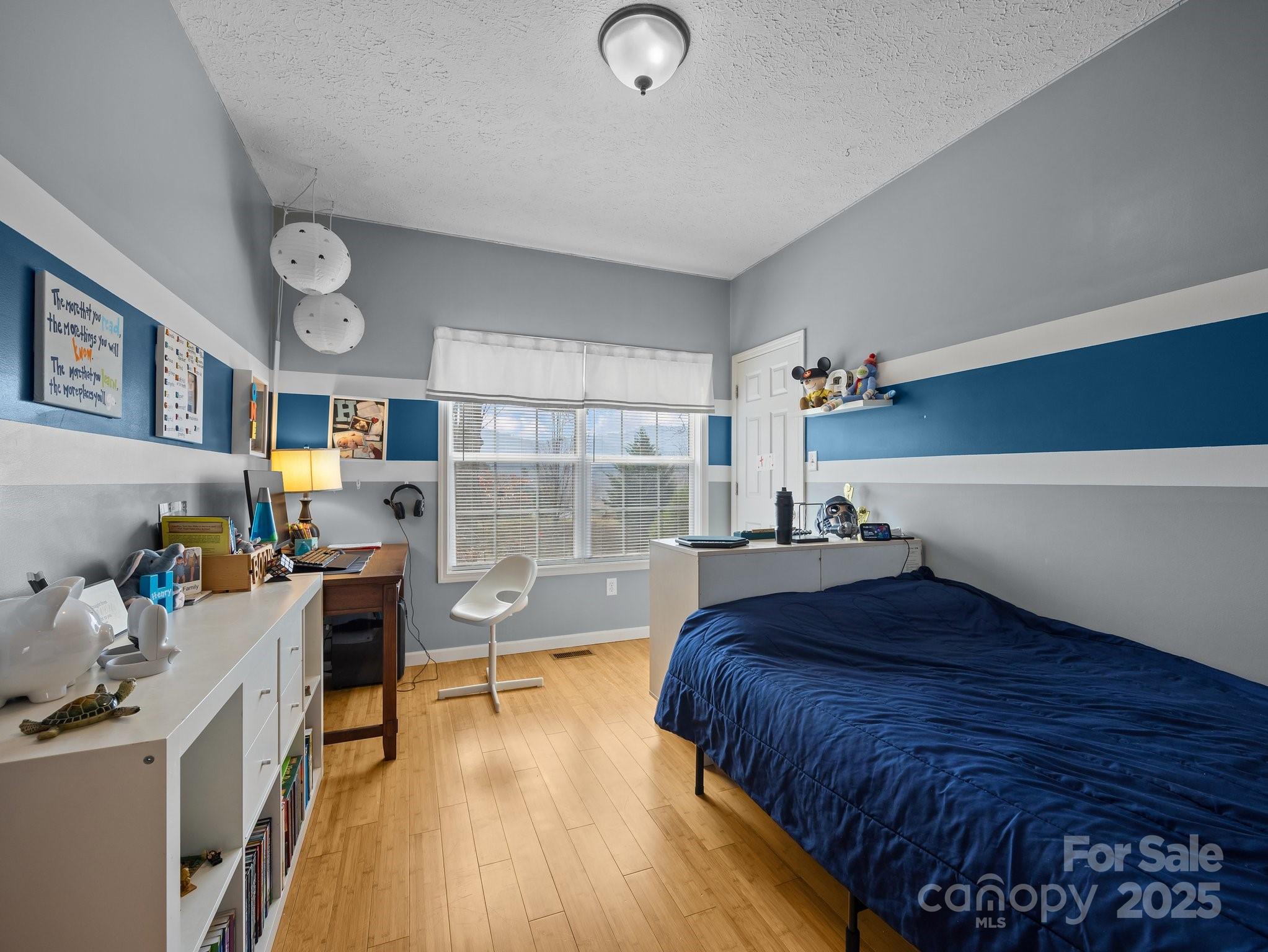 233 Thompson Cv Road Clyde, NC 28721 - Photo 18 of 25 a bedroom with a bed and a wooden floor