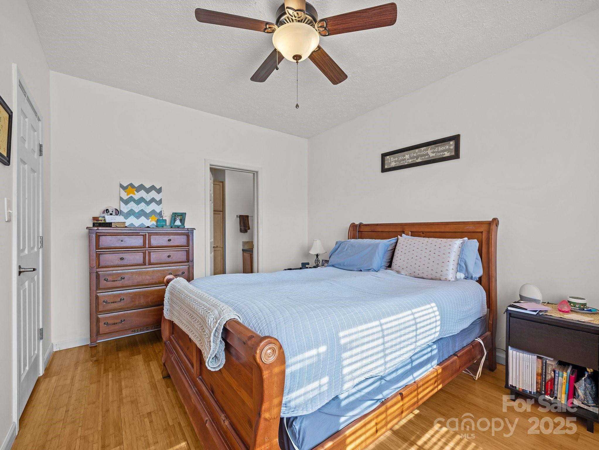 233 Thompson Cv Road Clyde, NC 28721 - Photo 19 of 25 a bedroom with a bed and a chandelier