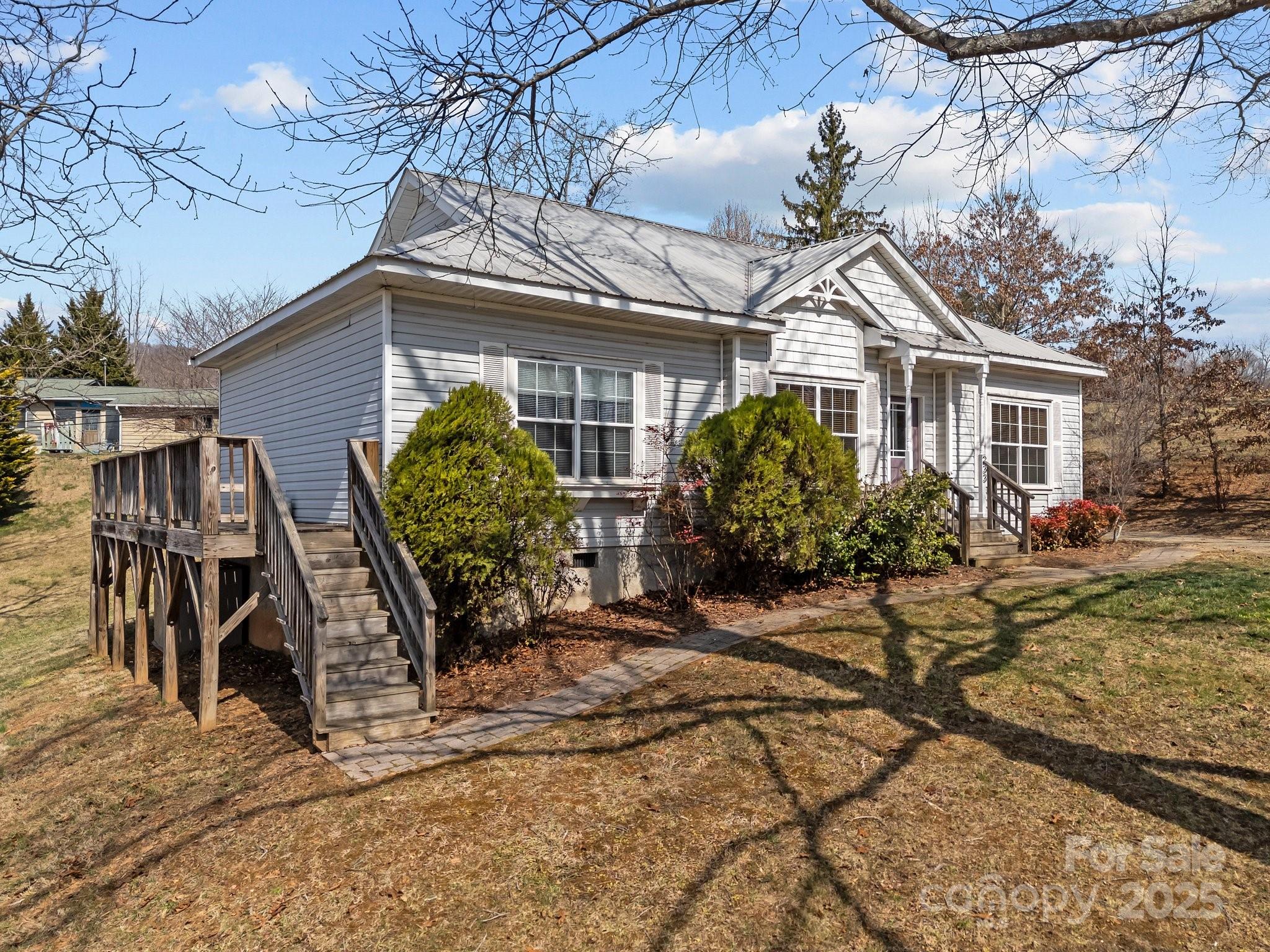 233 Thompson Cv Road Clyde, NC 28721 - Photo 2 of 25 a front view of a house with garden