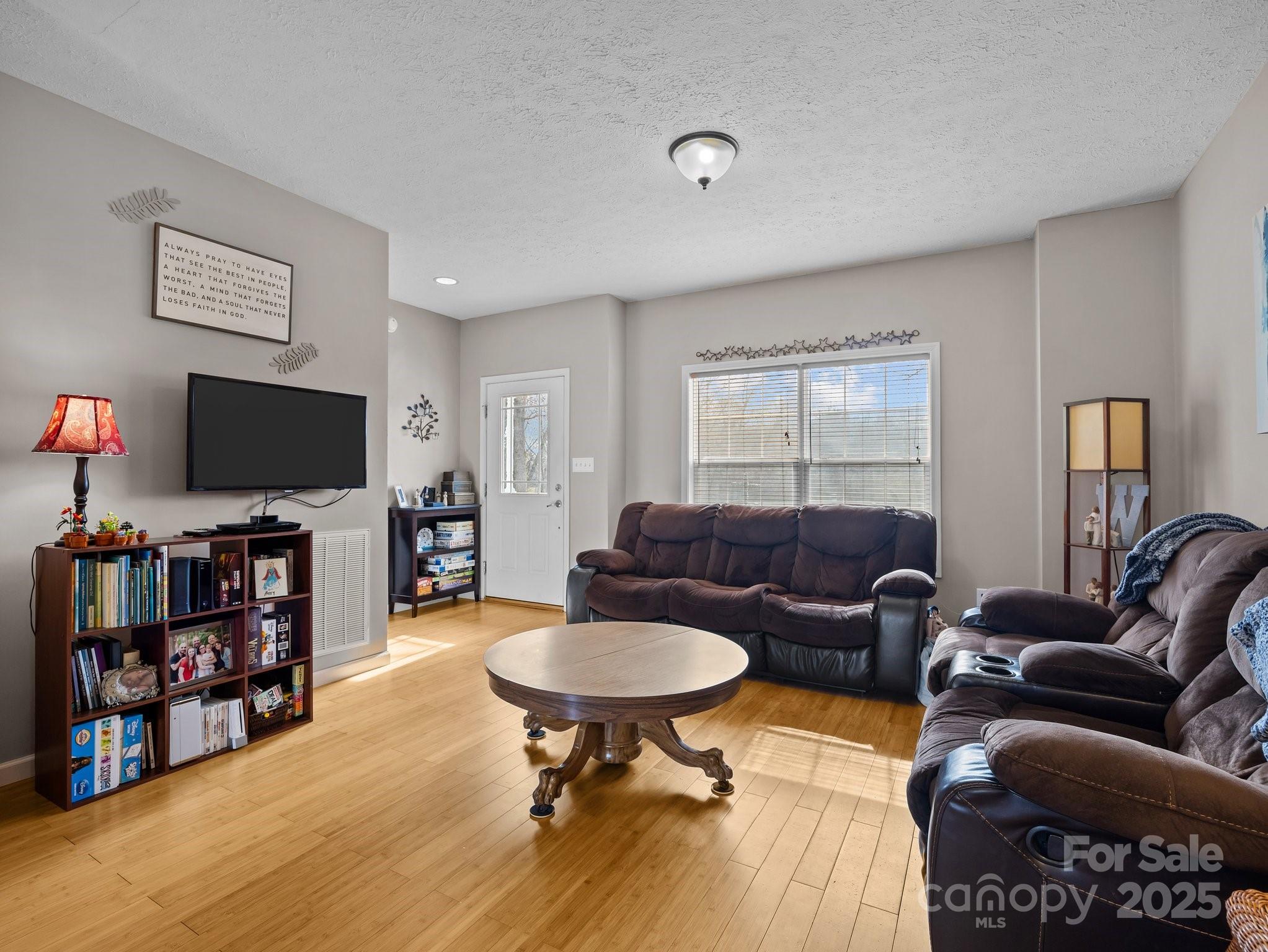 233 Thompson Cv Road Clyde, NC 28721 - Photo 7 of 25 a living room with furniture and a flat screen tv