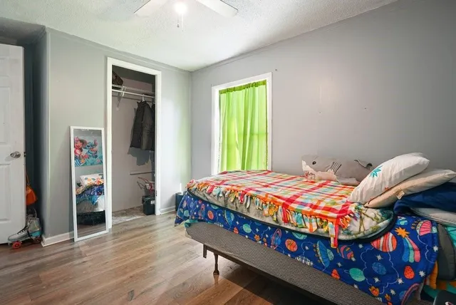 a bedroom with a bed and a window