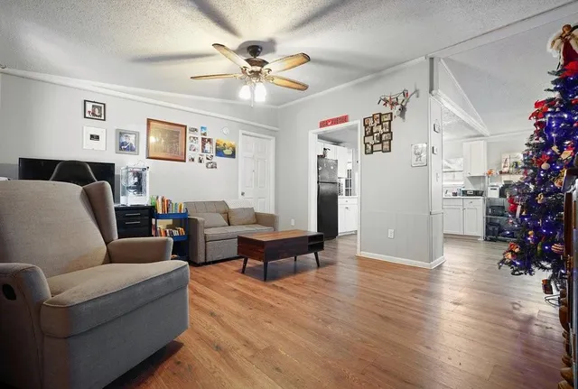 a living room with furniture and a chandelier