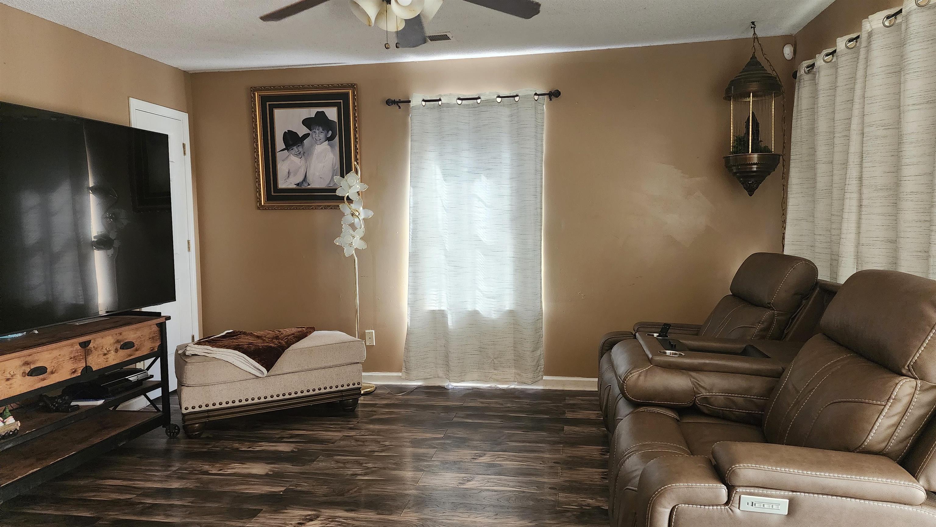 2638 Hawkins Mill Road Memphis, TN 38127 - Photo 2 of 13 Nice wood laminate flooring with lots of natural light and ceiling fan.