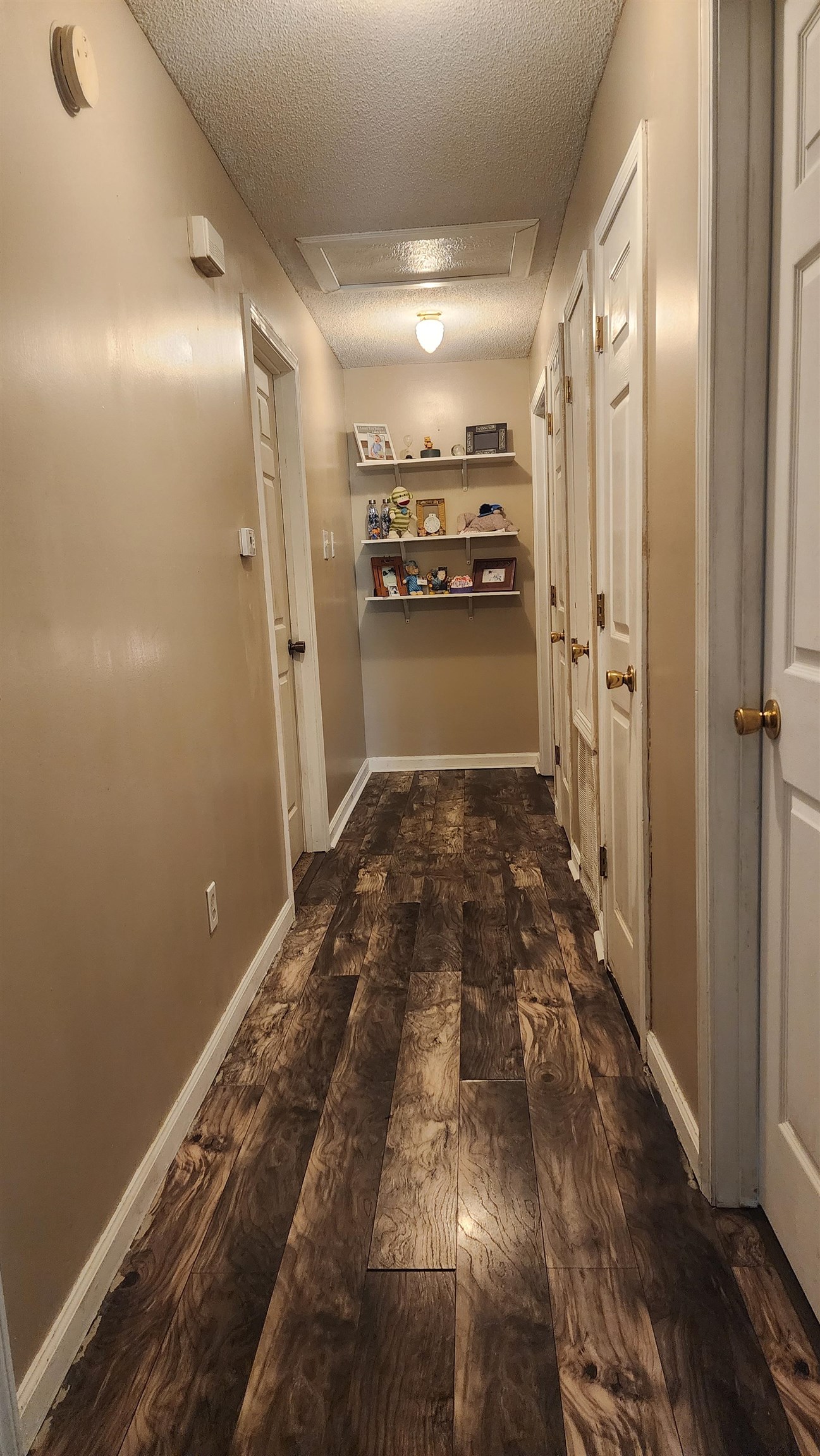 2638 Hawkins Mill Road Memphis, TN 38127 - Photo 9 of 13 Corridor featuring a textured ceiling and baseboards