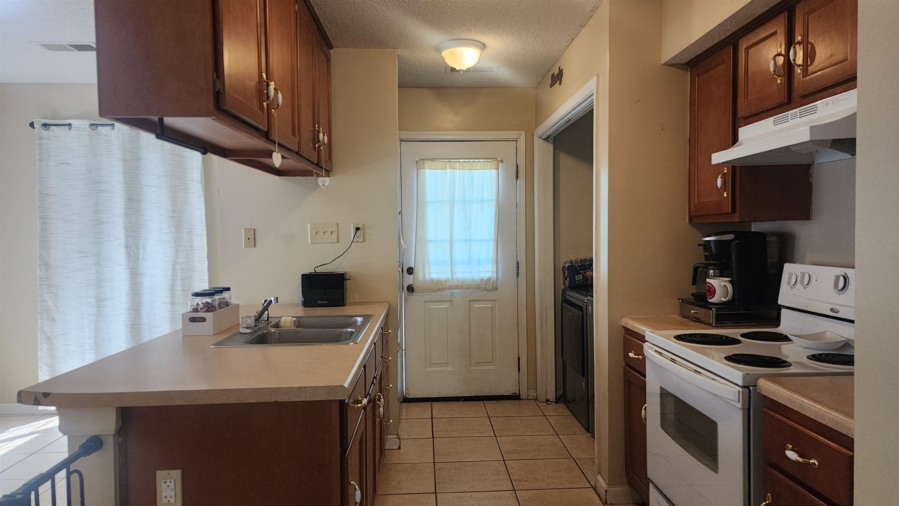2638 Hawkins Mill Road Memphis, TN 38127 - Photo 10 of 13 Kitchen featuring electric range with vent hood, refrigerator and pantry