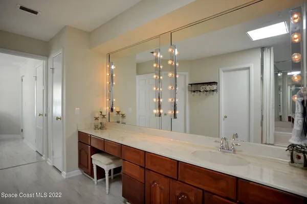a bathroom with a sink double vanity and a mirror