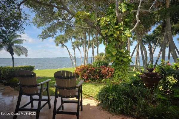 a view of an chairs and table in the patio