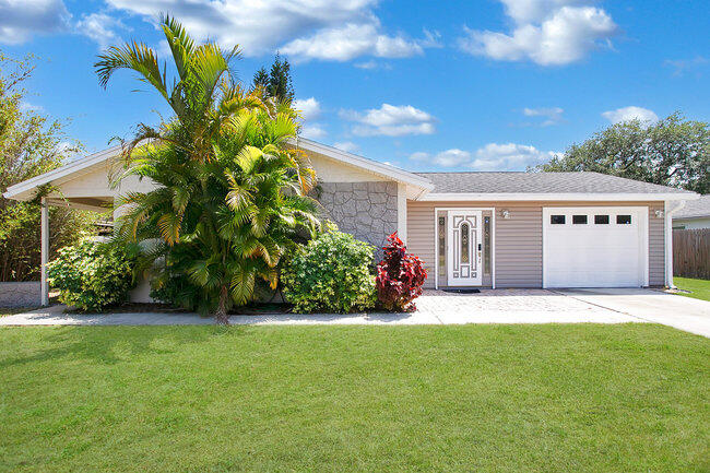 a front view of a house with a garden