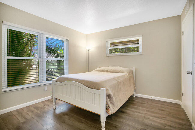 2879 Lancaster Road Melbourne, FL 32935 - Photo 12 of 28 a bedroom with a bed and a large window