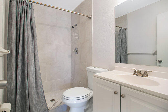 2879 Lancaster Road Melbourne, FL 32935 - Photo 13 of 28 a bathroom with a sink toilet and shower