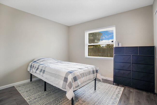 2879 Lancaster Road Melbourne, FL 32935 - Photo 14 of 28 a bedroom with a bed and a window