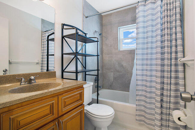 2879 Lancaster Road Melbourne, FL 32935 - Photo 15 of 28 a bathroom with a sink toilet vanity and shower